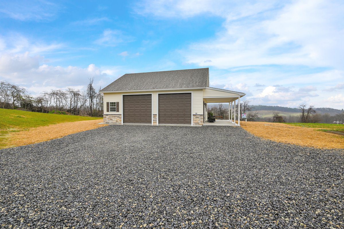 a driveway leading up to a custom 2-ar garage